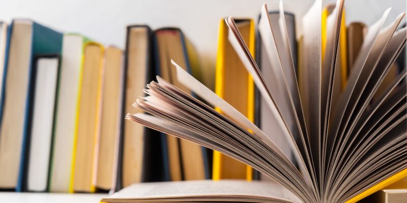 pile of paperback books on a table